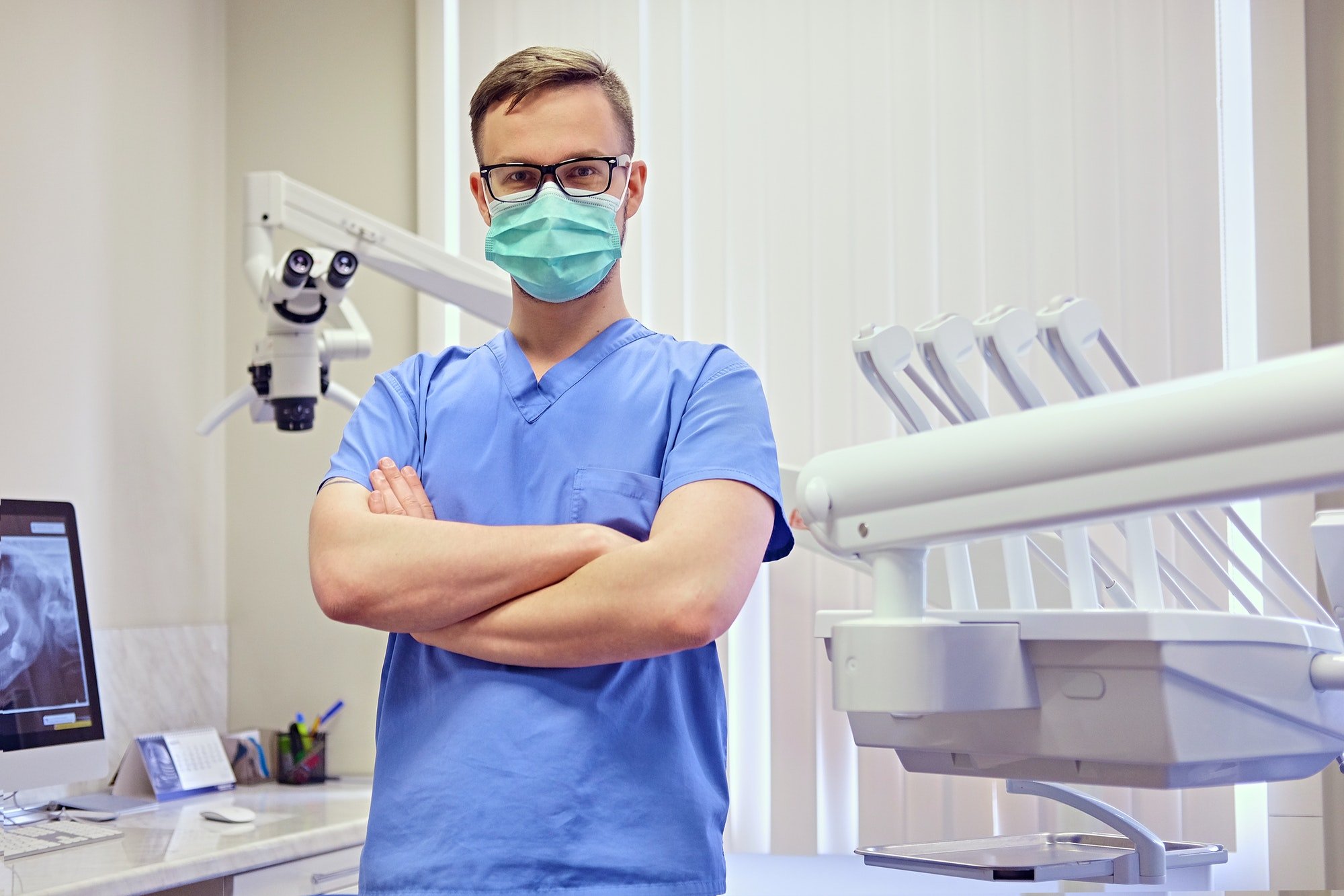 dentist-in-a-room-with-medical-equipment-on-background-.jpg